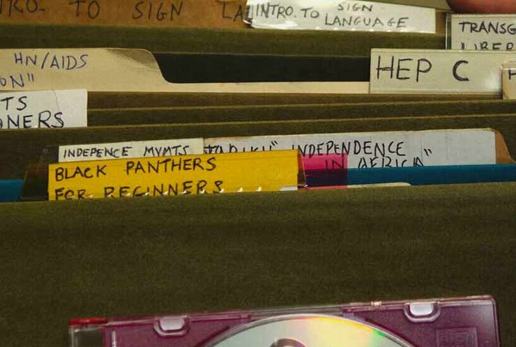 Several file folders; visible labels read "Black Panthers for Beginners", "Independence in Africa", "HEP C", "Intro to Sign Language", "HIV/AIDS", "Independence Mvmts", "Transgender Liberation", and "ACLU Rights of Prisoners"